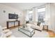A modern living room with large windows, a comfortable sofa, and a large flat-screen television at 1320 Fillmore St # 419, Charlotte, NC 28203