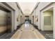 Interior lobby featuring elevators, marble floors, a bench, artwork, and access to mailboxes at 1320 Fillmore St # 419, Charlotte, NC 28203