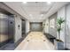 Building lobby featuring elevators, marble floors, a bench, and decorative plants at 1320 Fillmore St # 419, Charlotte, NC 28203