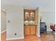 Charming wet bar area with wooden cabinets, granite countertop, and decorative backsplash at 13424 Portside Ct, Charlotte, NC 28278