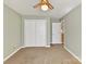 Bedroom with neutral walls, carpet, fan, and closet at 13424 Portside Ct, Charlotte, NC 28278