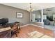 Cozy dining room with a modern chandelier, desk, and adjacent open-concept living area at 13424 Portside Ct, Charlotte, NC 28278