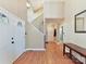 Inviting foyer with hardwood floors, staircase and a stylish console table at 13424 Portside Ct, Charlotte, NC 28278