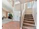 Open foyer featuring hardwood floors, a staircase, and a view into the bright living room at 13424 Portside Ct, Charlotte, NC 28278