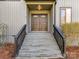 Inviting front entryway featuring double doors with glass inlays and traditional wood banisters at 13424 Portside Ct, Charlotte, NC 28278
