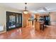 Open kitchen featuring a breakfast island, wooden cabinetry, modern appliances, and outdoor access at 13424 Portside Ct, Charlotte, NC 28278