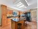 Spacious kitchen with an island, wooden cabinets, and stainless steel appliances at 13424 Portside Ct, Charlotte, NC 28278