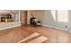 Open-concept living room showcasing hardwood floors and seamless flow into the kitchen at 13424 Portside Ct, Charlotte, NC 28278