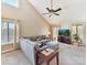 Sunlit living room with a comfortable sectional sofa and a ceiling fan at 13424 Portside Ct, Charlotte, NC 28278