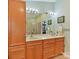 Bright main bathroom showcasing a double vanity with ample storage, a large mirror, and tiled shower at 13424 Portside Ct, Charlotte, NC 28278