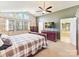 Bright main bedroom featuring vaulted ceilings, an en suite bathroom, and comfortable plaid bedding at 13424 Portside Ct, Charlotte, NC 28278