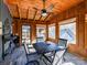 Relaxing sunroom with wood-paneled walls, ceiling fan and an outdoor view at 13424 Portside Ct, Charlotte, NC 28278