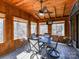 Cozy sunroom featuring wood paneled walls, ceiling fan and views to the outdoor at 13424 Portside Ct, Charlotte, NC 28278