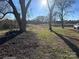 Expansive property showcasing mature trees, driveway and distant view of the residence at 1415 S Morgan St, Shelby, NC 28152