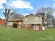 Expansive backyard with lush lawn, mature trees, and partial shade at 1465 Earl St, Hickory, NC 28602