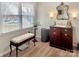 Bathroom featuring a charming vanity with a sink, mirror, and bench near a bright window at 1465 Earl St, Hickory, NC 28602
