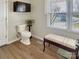 Bright bathroom features wood-look floors, a comfort height toilet, and a window bench at 1465 Earl St, Hickory, NC 28602