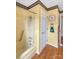 Bathroom with a shower/tub combo, wood-look floors, and decorative accents at 1465 Earl St, Hickory, NC 28602