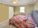 Cozy bedroom with a patterned bedspread, decorative border, and a ceiling fan at 1465 Earl St, Hickory, NC 28602