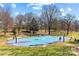Outdoor basketball court with benches and lush greenery in the background at 1517 Cleveland Ave # D, Charlotte, NC 28203