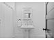 Bright bathroom features a pedestal sink and classic design elements at 1517 Cleveland Ave # D, Charlotte, NC 28203