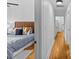Hallway view to bedroom featuring hardwood floors, neutral walls, and modern decor at 1517 Cleveland Ave # D, Charlotte, NC 28203