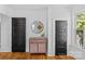 Charming hallway features a hardwood floor, doors, and a modern mirror at 1517 Cleveland Ave # D, Charlotte, NC 28203