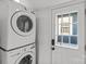 Laundry room features a stacked washer and dryer and a windowed exterior door at 1517 Cleveland Ave # D, Charlotte, NC 28203