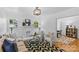 A cozy living room with a painted fireplace, hardwood floors, and black and white geometric rug at 1517 Cleveland Ave # D, Charlotte, NC 28203