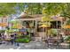 Inviting outdoor seating area at 300 East Restaurant, featuring tables, umbrellas, and lush landscaping at 1517 Cleveland Ave # D, Charlotte, NC 28203