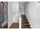 Interior view of a staircase featuring hardwood steps, white banisters, and wainscoting at 1517 Cleveland Ave # D, Charlotte, NC 28203