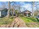 A brick walkway leads to the house with lush greenery and towering trees at 1517 Cleveland Ave # D, Charlotte, NC 28203