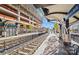 Modern train stop featuring an arched roof design, convenient seating, and clear signage for East/West Boulevard destinations at 1517 Cleveland Ave # D, Charlotte, NC 28203