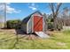 Outbuilding on a landscaped lot with a red door, ramp, and green grass at 1558 Pine Creek Rd, Gastonia, NC 28056