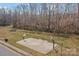 Outdoor basketball court is surrounded by a grassy field and mature trees at 166 Chere Helen Dr, Mooresville, NC 28115