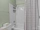 Bathroom with a tiled shower/tub, soft green walls, and patterned shower curtain at 166 Chere Helen Dr, Mooresville, NC 28115