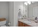 Cozy bathroom featuring granite countertop, stylish sink, decorative mirror, and a neutral color palette at 166 Chere Helen Dr, Mooresville, NC 28115