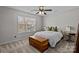 Bright bedroom featuring a large window, neutral carpet, ceiling fan, and comfortable furnishings at 166 Chere Helen Dr, Mooresville, NC 28115