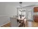 Charming dining room featuring a rustic wood table, elegant chairs, and modern lighting at 166 Chere Helen Dr, Mooresville, NC 28115