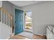 Inviting entryway with a vibrant teal door and adjacent staircase creating a warm welcome at 166 Chere Helen Dr, Mooresville, NC 28115