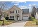 Charming two-story home with tan siding, green shutters, and a one-car garage at 166 Chere Helen Dr, Mooresville, NC 28115