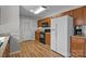 Functional kitchen featuring wooden cabinetry, sleek appliances, and an adjacent exterior door at 166 Chere Helen Dr, Mooresville, NC 28115