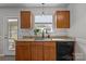 Kitchen area featuring wood cabinets, granite counters, modern appliances, and a stylish sink with a window view at 166 Chere Helen Dr, Mooresville, NC 28115