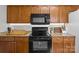 Kitchen showcasing wooden cabinets, black appliances, granite countertops, and ample storage space at 166 Chere Helen Dr, Mooresville, NC 28115