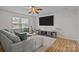 Spacious living room featuring a plush sectional sofa, large TV, and natural light at 166 Chere Helen Dr, Mooresville, NC 28115