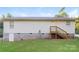 Backyard view showcasing a white siding home with a small deck and a well-maintained lawn at 19 Church St, York, SC 29745