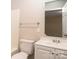 Traditional bathroom featuring white fixtures, vanity, a large mirror, and neutral wall paint at 19 Church St, York, SC 29745