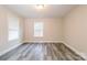 Bedroom featuring neutral walls, one window, and gray wood-look floors at 19 Church St, York, SC 29745