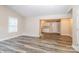 Open-concept living room featuring modern floors and neutral paint, leading into kitchen at 19 Church St, York, SC 29745