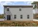 Backyard view showcasing a two-story home with a patio and lush greenery at 205 Athens Dr # 31, Salisbury, NC 28147